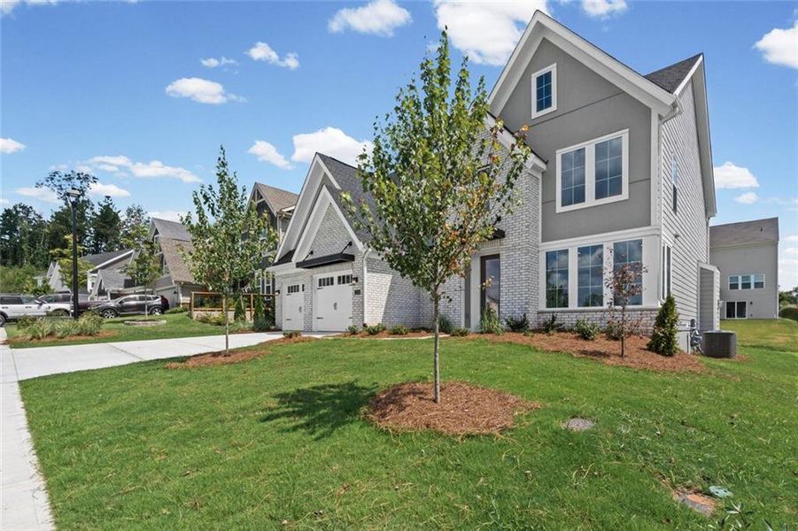 Front exterior of a new home in Twin Lakes, Hoschton, GA, highlighting curb appeal (Image 21).