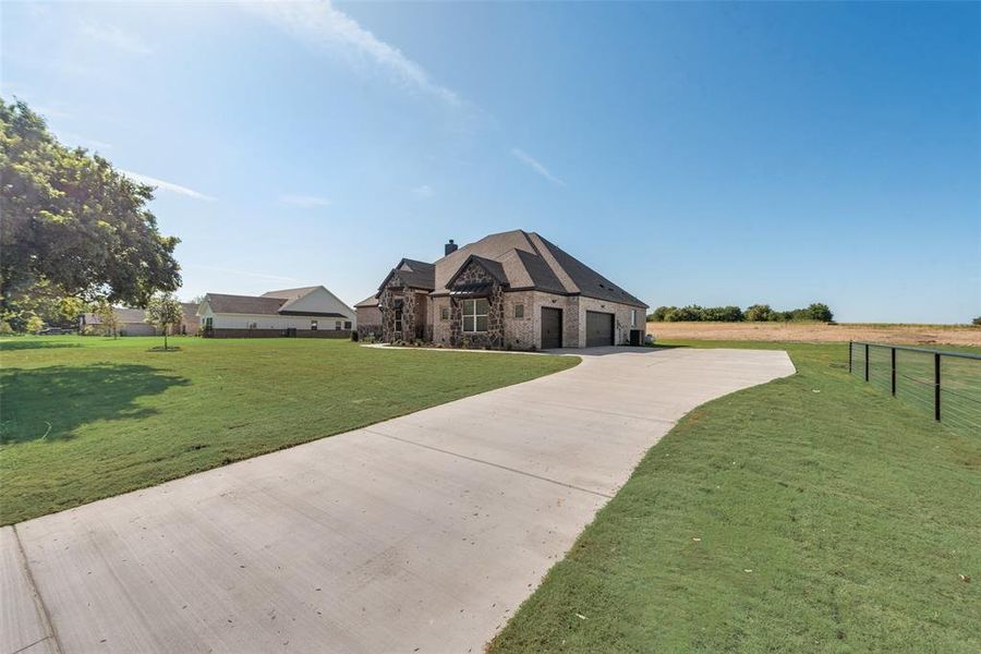 View of front of house with a garage and a front yard