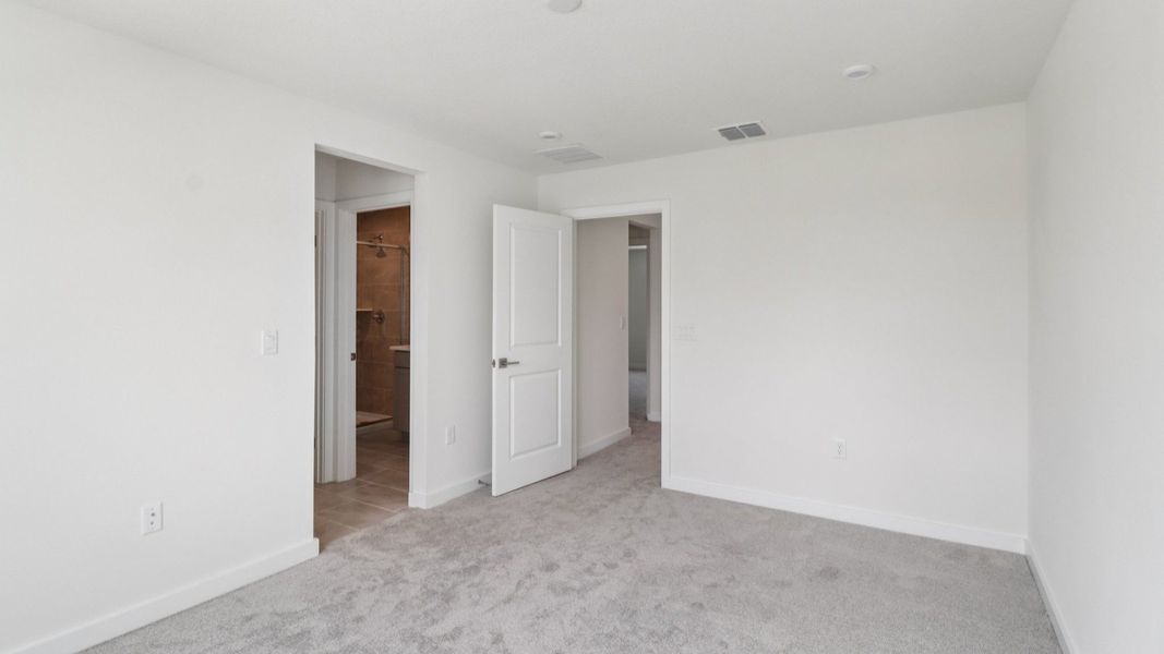 Primary Suite with en suite bath with dual sinks in the Monterey End Townhome by DRB Homes - Cyrene at Harmony in St Cloud FL