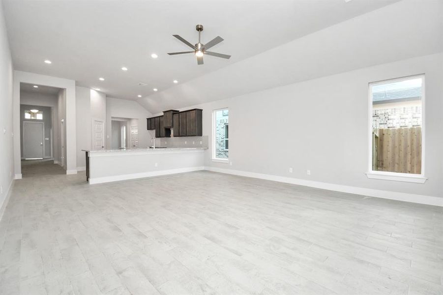 Take another glimpse into the heart of the home with this additional view of the family room—a sprawling space ready to accommodate all your gatherings. Sample photo of completed home. Actual colors and selections will vary.