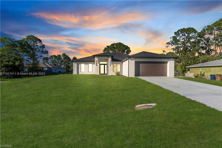 Front exterior of a new home in , Lehigh Acres, FL, highlighting curb appeal (Image 1).