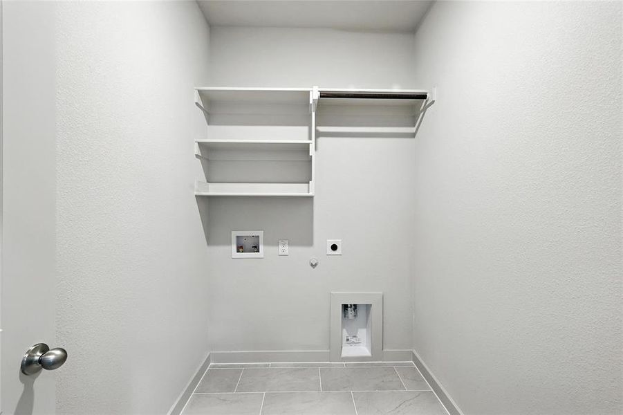 Laundry area with gas dryer hookup, electric dryer hookup, hookup for a washing machine, and marble finish flooring Laundry area with gas dryer hookup, electric dryer hookup, hookup for a washing machine, and marble finish flooring