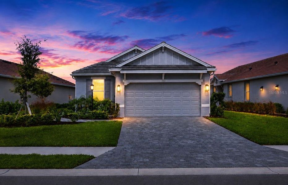 Front exterior of a new home in Esplanade at Azario Lakewood Ranch, Bradenton, FL, highlighting curb appeal (Image 1). Front exterior of a new home in Esplanade at Azario Lakewood Ranch, Bradenton, FL, highlighting curb appeal (Image 1).