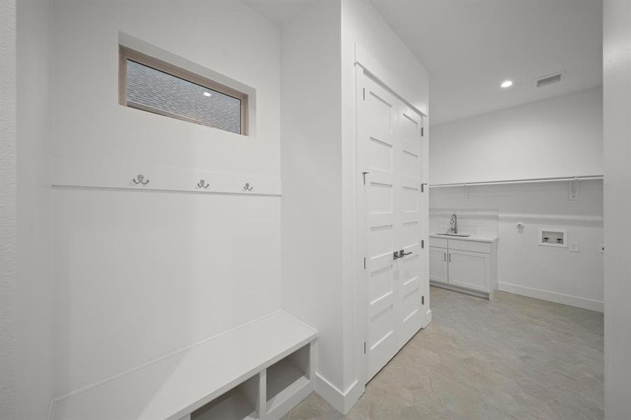 Mudroom with recessed lighting and baseboards