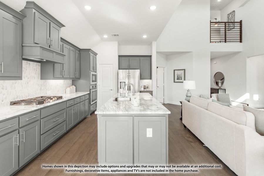 Open kitchen with gray cabinets, marble island, gas cooktop, and stainless appliances, open to living area with hardwood floors. Open kitchen with gray cabinets, marble island, gas cooktop, and stainless appliances, open to living area with hardwood floors.