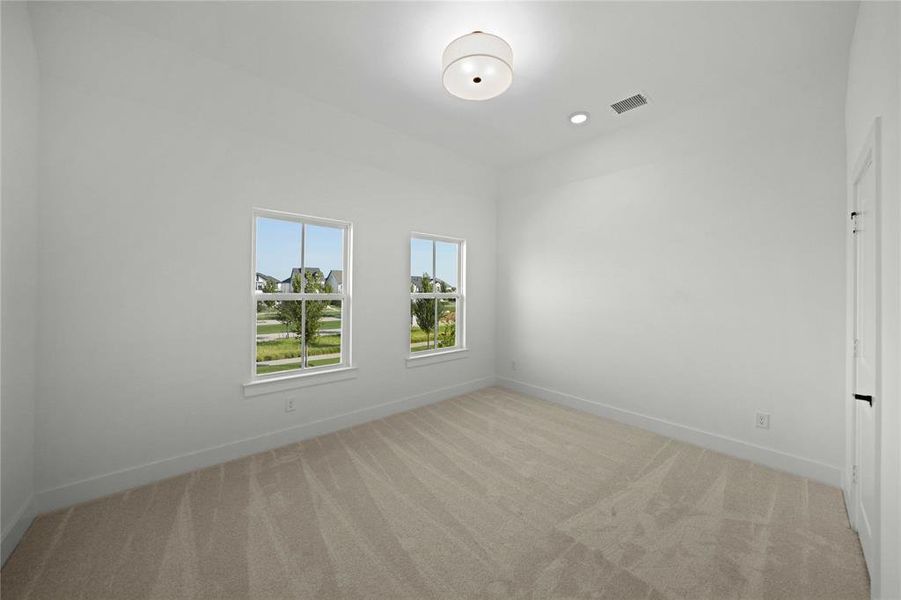 Spare room with light colored carpet and recessed lighting Spare room with light colored carpet and recessed lighting