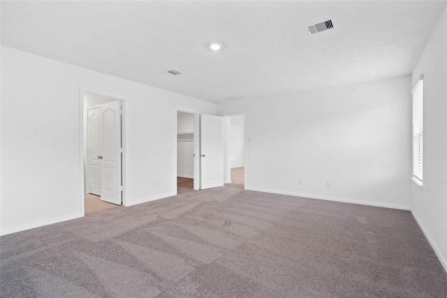 Additional view from primary suite to walk-in closet and primary bathroom Additional view from primary suite to walk-in closet and primary bathroom