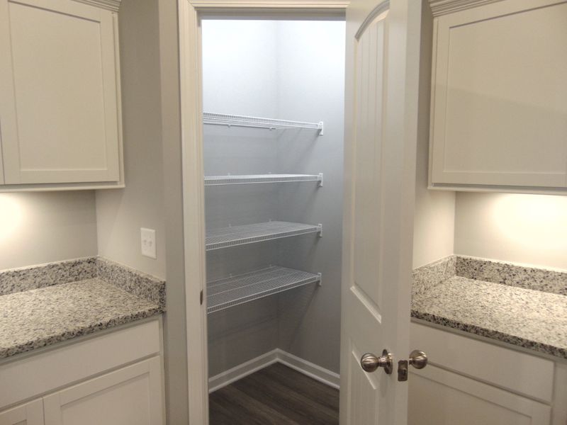The kitchen where you can cook all your specialty dishes with love. This kitchen has under cabinet lights, included steel appliances, as well as a modern and large island and sink.