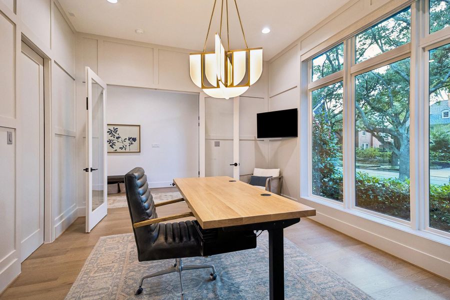 Picture-perfect front office windows frame serene views of the mature, tree-lined street.