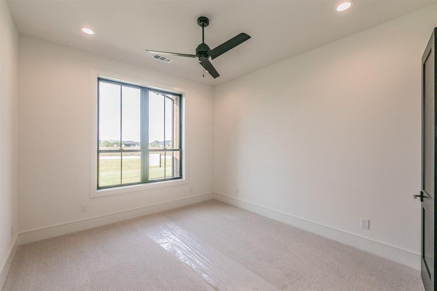 Spare room featuring recessed lighting, light carpet, and a ceiling fan