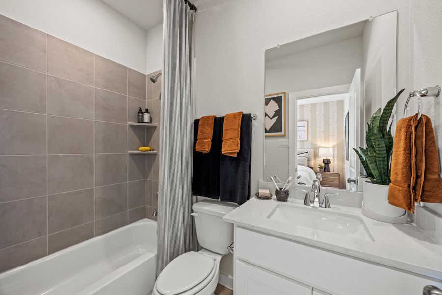 A bathroom with a tub toilet and sink. A bathroom with a tub toilet and sink.