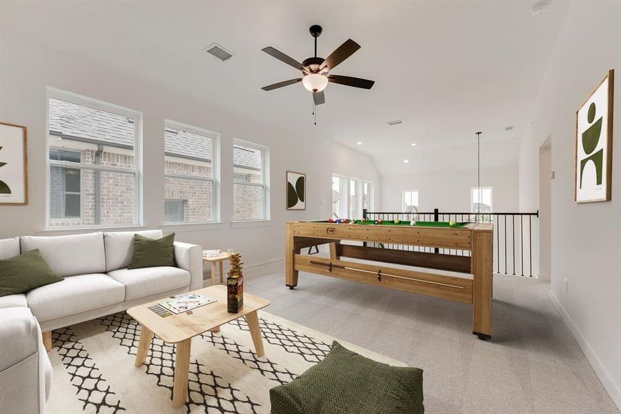 Living area with light carpet, a ceiling fan, recessed lighting, and vaulted ceiling Living area with light carpet, a ceiling fan, recessed lighting, and vaulted ceiling