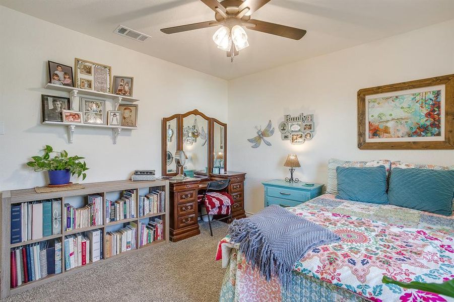 Bedroom featuring carpet floors and ceiling fan Bedroom featuring carpet floors and ceiling fan
