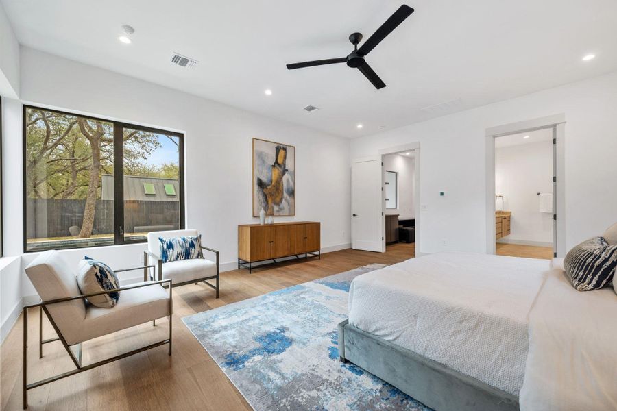 Bedroom featuring wood finished floors, a ceiling fan, connected bathroom, and recessed lighting
