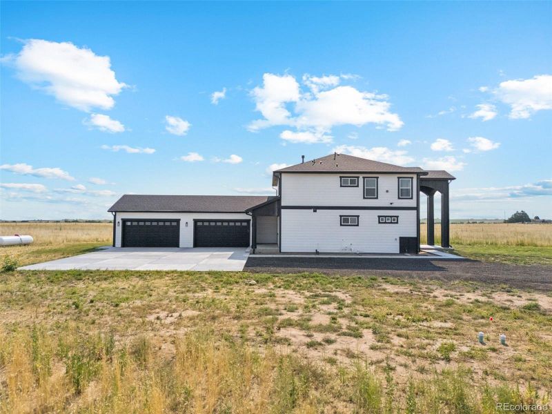 Front exterior of a new home in , Bennett, CO, highlighting curb appeal (Image 23).