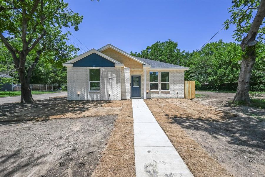 Contemporary exterior featuring white brick siding and a deep blue entry door Contemporary exterior featuring white brick siding and a deep blue entry door