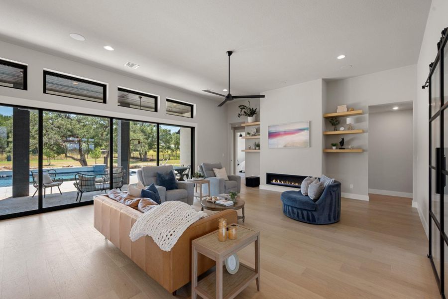 Gleaming wood floors and a sleek modern fireplace define this open and airy living space.