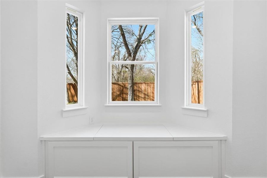 Rear secondary bedroom with seating/storage under window