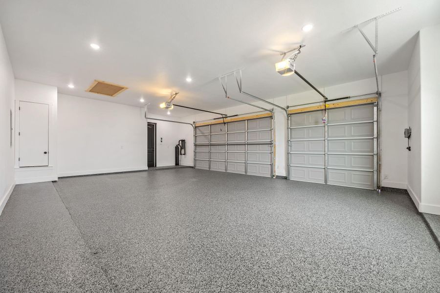 Garage with recessed lighting and a garage door opener