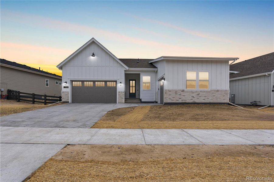 Front exterior of a new home in Retreat at The Canyons, Castle Pines, CO, highlighting curb appeal (Image 25).