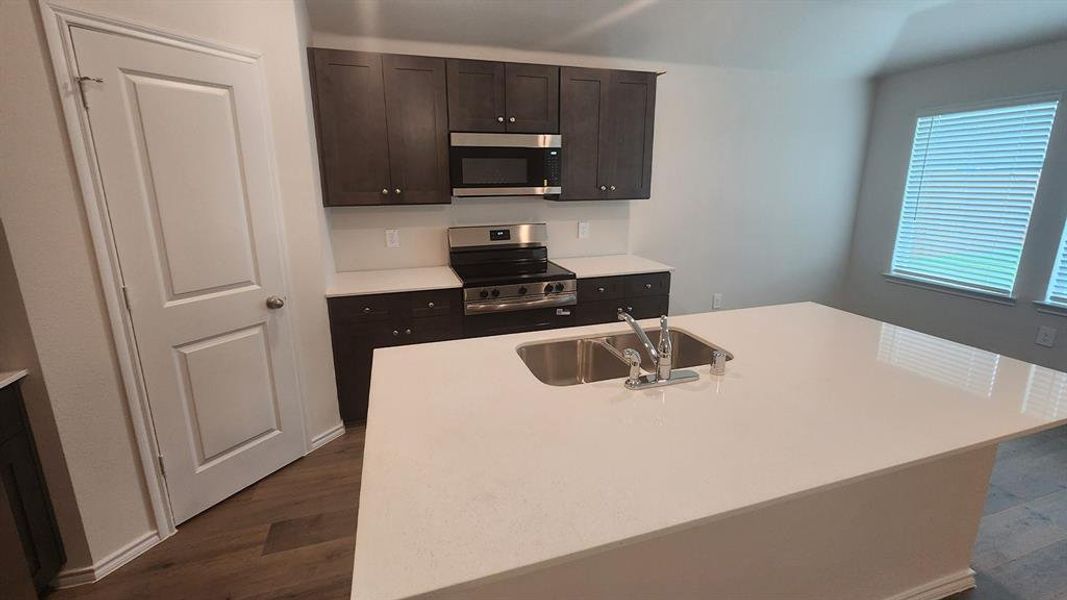 Kitchen island with an undermount double basin stainless steel sink and a gooseneck faucet Kitchen island with an undermount double basin stainless steel sink and a gooseneck faucet