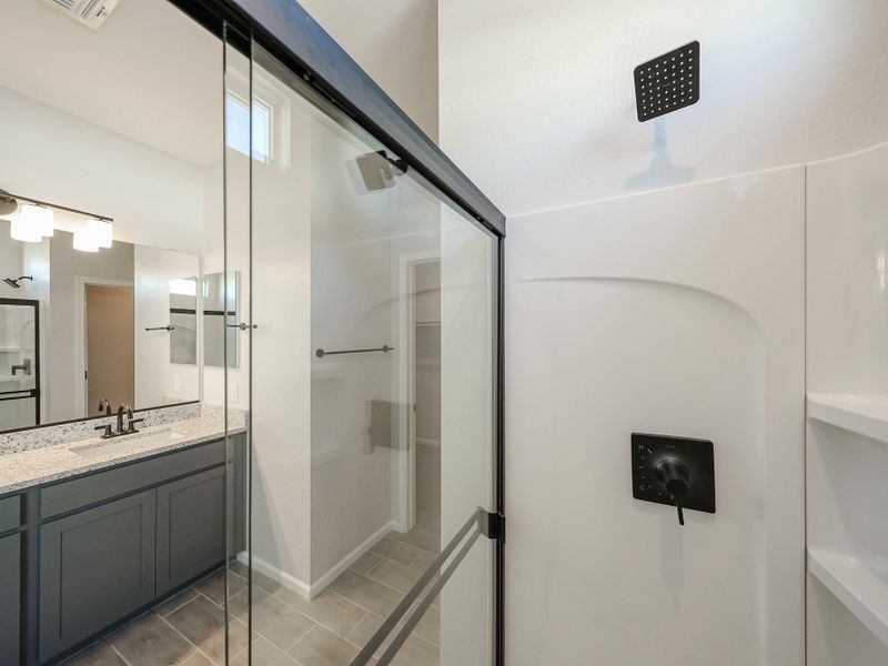 A bathroom with a glass shower. A bathroom with a glass shower.