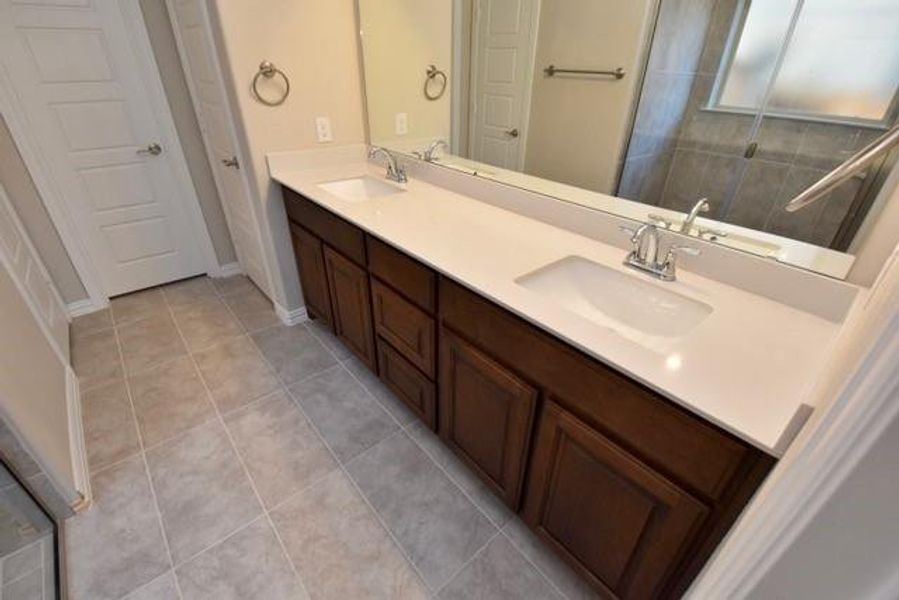 Bathroom with vanity, a stall shower, and light tile patterned flooring Bathroom with vanity, a stall shower, and light tile patterned flooring