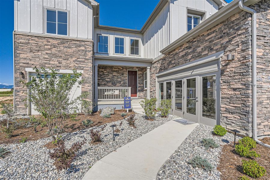 A stone walkway leading to a house. A stone walkway leading to a house.