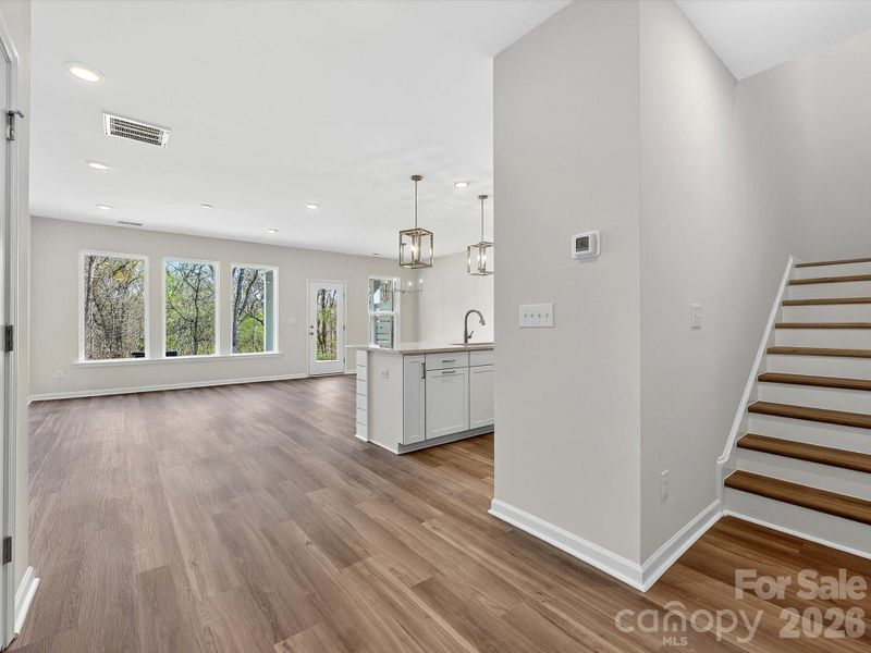 3 large picture windows allow the room to be bathe with natural light. LVP flooring throughout the main level. LVP Composite stair treads. Backyard is very private with views of the trees and nature preserve