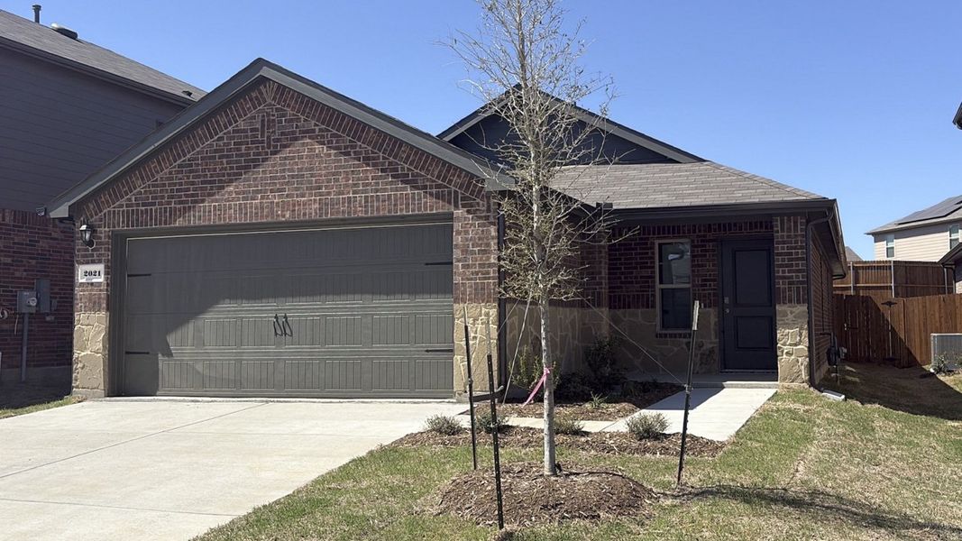 Front exterior of a new home in Wildcat Ranch, Crandall, TX, highlighting curb appeal (Image 2). Front exterior of a new home in Wildcat Ranch, Crandall, TX, highlighting curb appeal (Image 2).