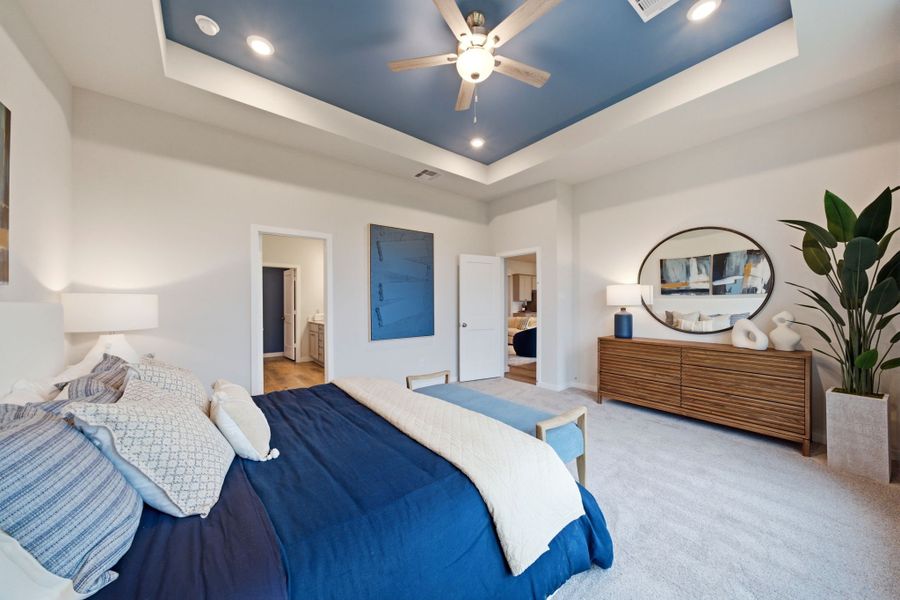 A bedroom with a bed and a fan. A bedroom with a bed and a fan.