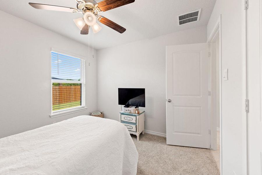Bedroom with carpet floors and a ceiling fan