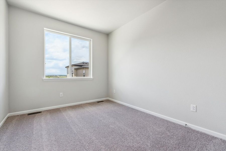 A room with a window and a carpet. A room with a window and a carpet.