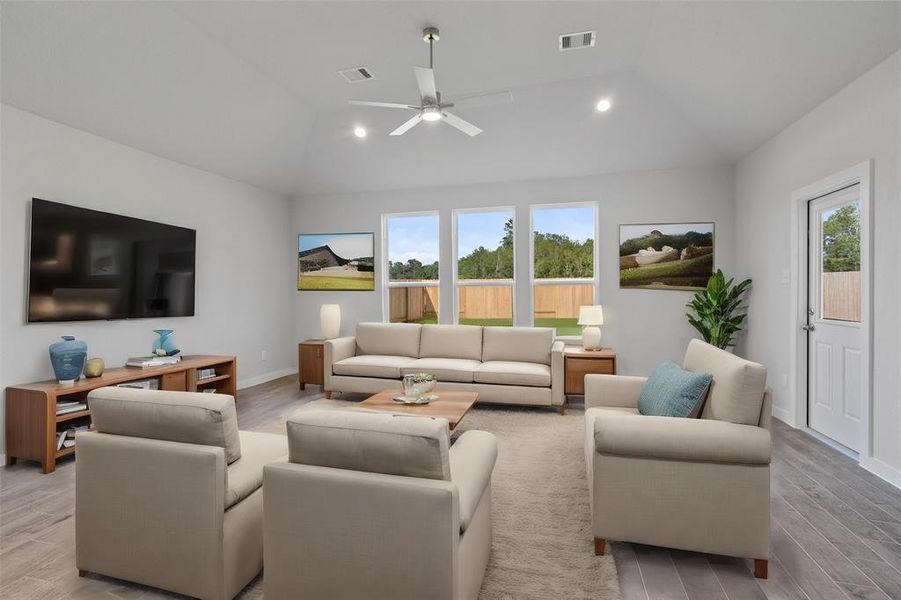 Gather the family and guests together in your lovely living room! Featuring high ceilings, recessed lighting, ceiling fan, custom paint, gorgeous floors and large windows that provide plenty of natural lighting throughout the day.