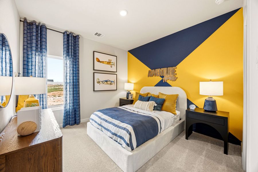 A bedroom with a bed and a desk.