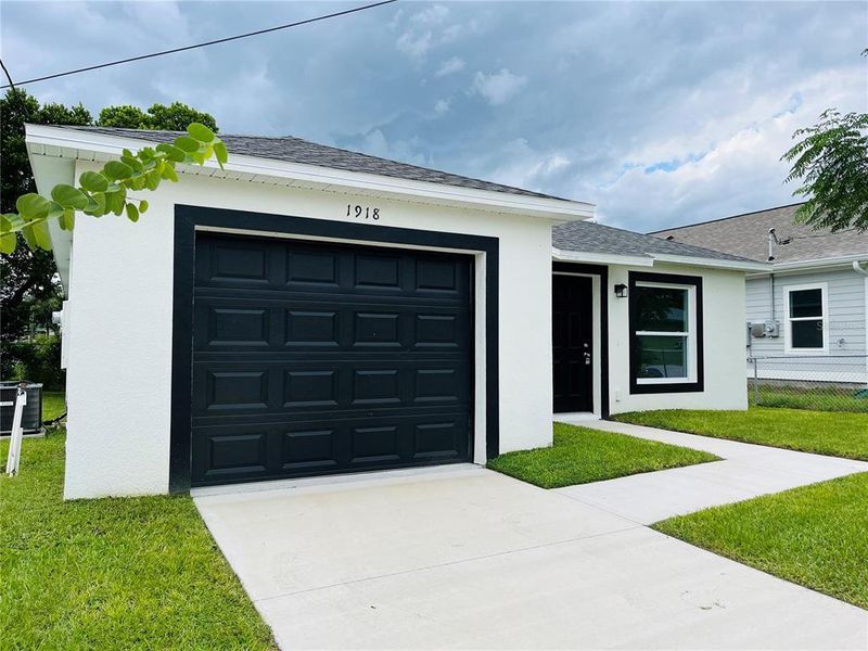Front exterior of a new home in , Haines City, FL, highlighting curb appeal (Image 8). Front exterior of a new home in , Haines City, FL, highlighting curb appeal (Image 8).