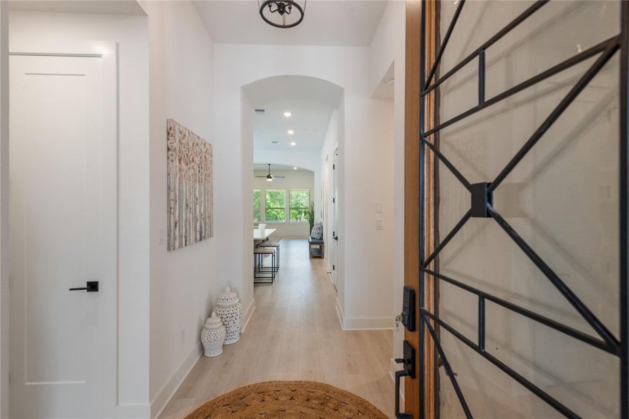 Enter into a bright hallway featuring light-toned flooring and recessed lighting. Enter into a bright hallway featuring light-toned flooring and recessed lighting.