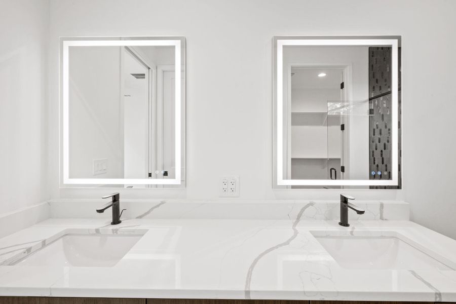 Dual sinks, integrated lighting at primary bathroom