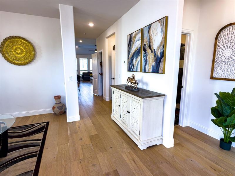 Corridor with light wood-style floors and recessed lighting
