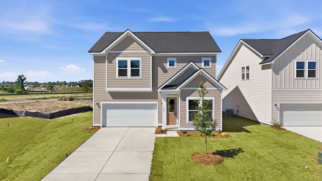 Front exterior of a new home in Blue Heron Retreat, Little River, SC, highlighting curb appeal (Image 1). Front exterior of a new home in Blue Heron Retreat, Little River, SC, highlighting curb appeal (Image 1).