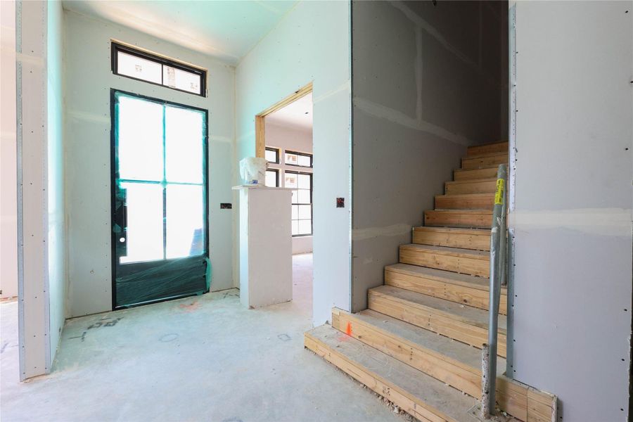 Guests are greeted by Custom metal door w/ transom, engineered wood floors, 12ft ceilings and wide entry way.