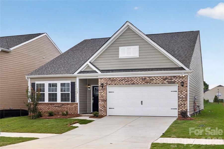 Front exterior of a new home in Secrest Commons, Monroe, NC, highlighting curb appeal (Image 2). Front exterior of a new home in Secrest Commons, Monroe, NC, highlighting curb appeal (Image 2).