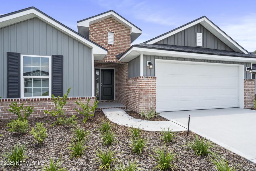 Front exterior of a new home in Shadow Crest at Rolling Hills, Green Cove Springs, FL, highlighting curb appeal (Image 1). Front exterior of a new home in Shadow Crest at Rolling Hills, Green Cove Springs, FL, highlighting curb appeal (Image 1).