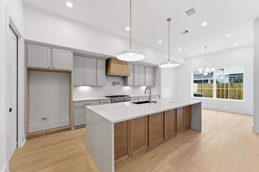 Gourmet style kitchen has a large island and ample cabinet space.