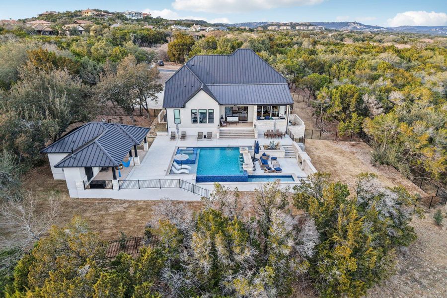 Situated on a generous 1.003-acre lot, this home offers the ultimate private resort experience.