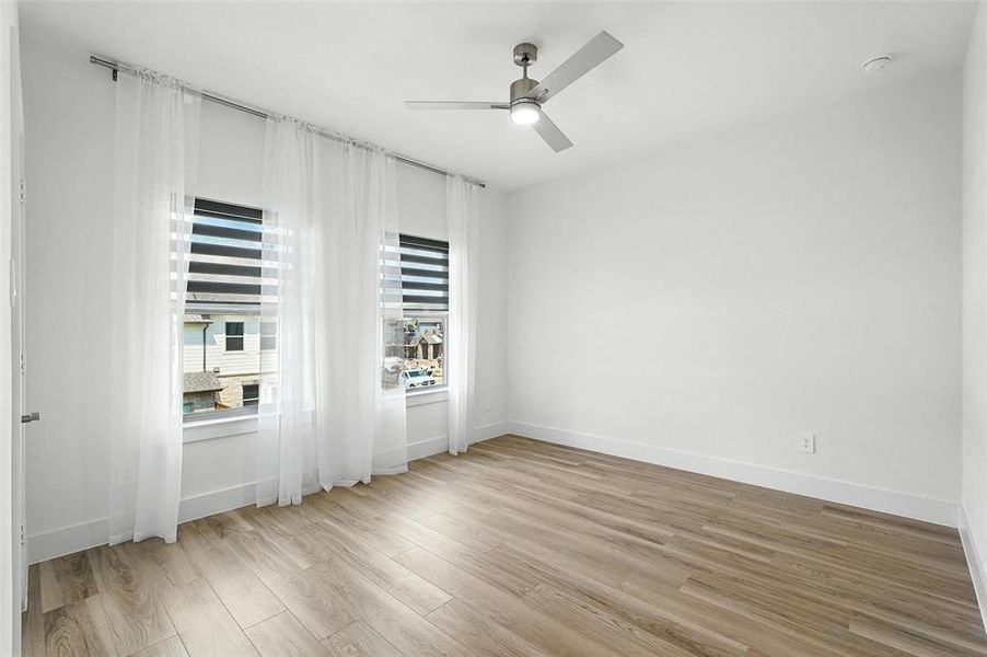 Unfurnished room with light wood-type flooring and ceiling fan