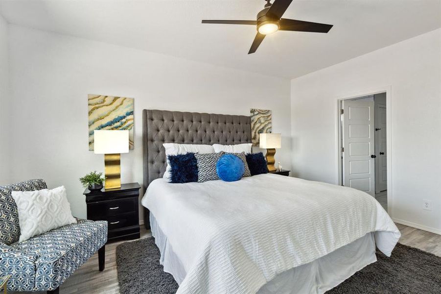 Bedroom with ceiling fan and hardwood / wood-style floors