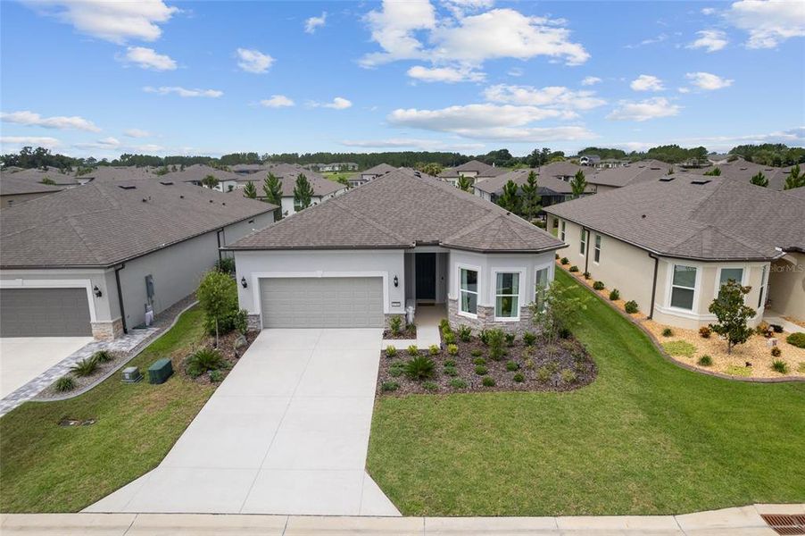 Front exterior of a new home in Del Webb Stone Creek, Ocala, FL, highlighting curb appeal (Image 22). Front exterior of a new home in Del Webb Stone Creek, Ocala, FL, highlighting curb appeal (Image 22).