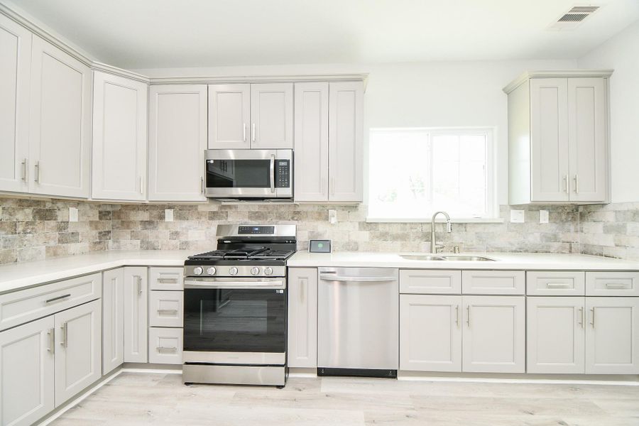 Discover a spectacular kitchen featuring sleek stainless steel appliances, perfect for culinary enthusiasts.