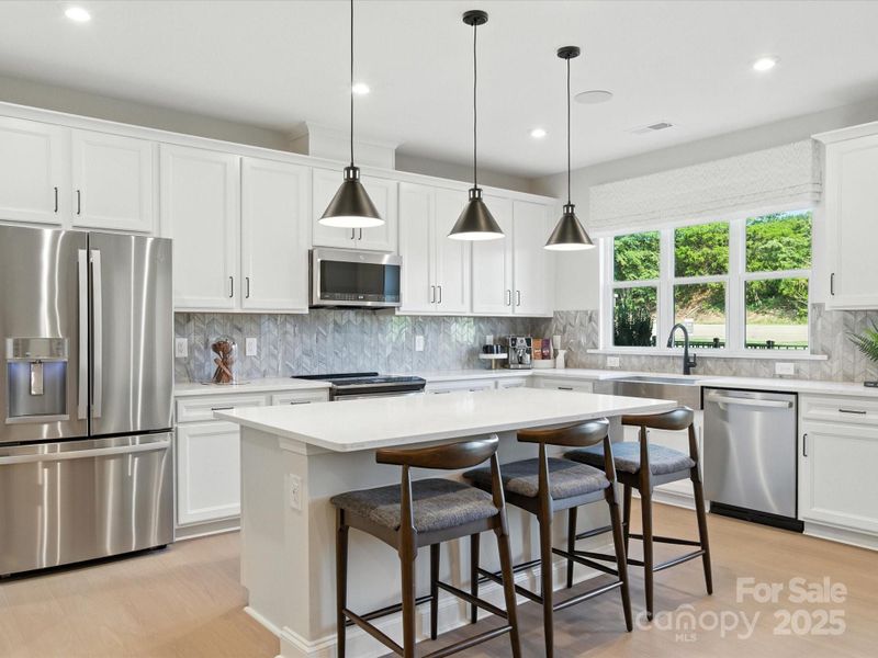 The heart of the home draws you in with designer selected finishes. *Model Photos | Actual finishes, orientation, and structural selections may vary.